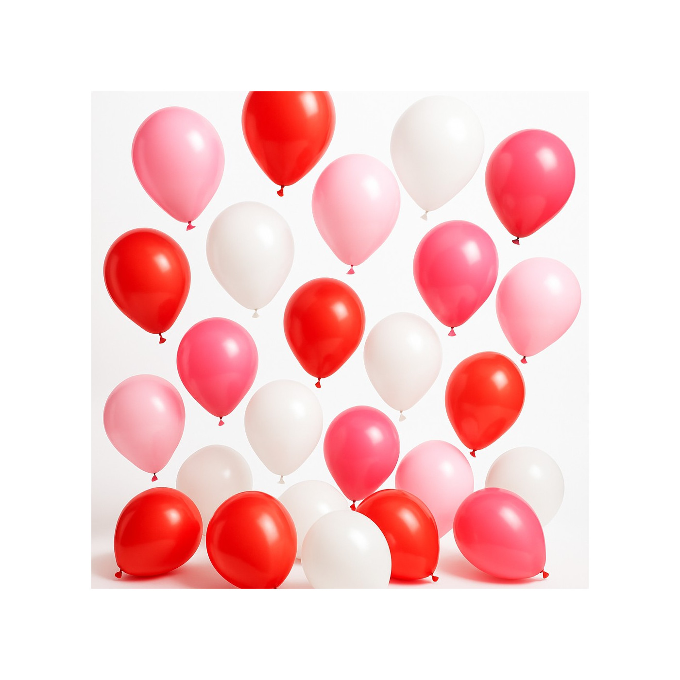 Röda, rosa och vita ballonger svävar elegant i luften, ger en livlig känsla av glädje.